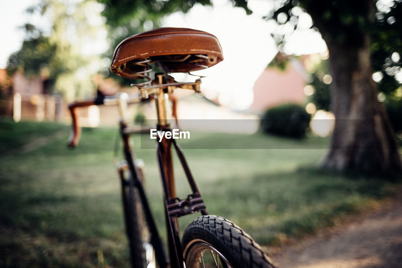 Close-up of bicycle wheel on field