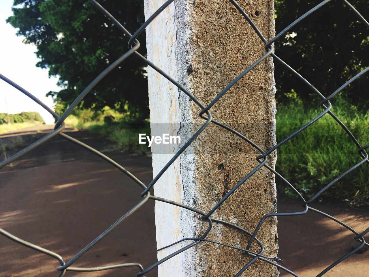 Full frame shot of chainlink fence against trees