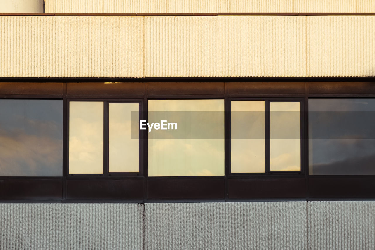 Building against sky seen through glass window