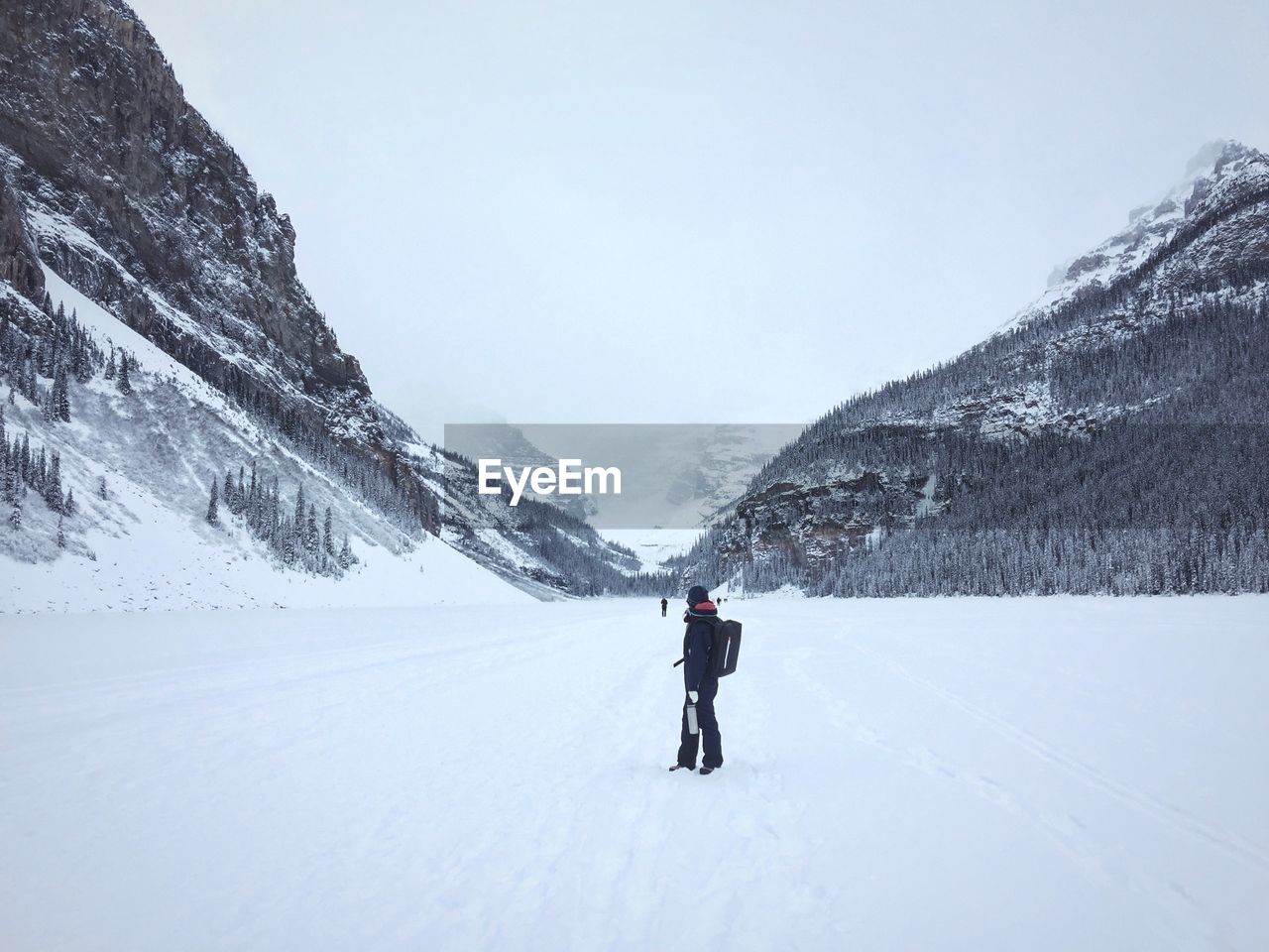 Young man skiing against on snowcapped mountains