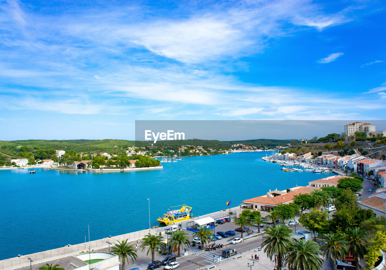 High angle view of city by sea against sky