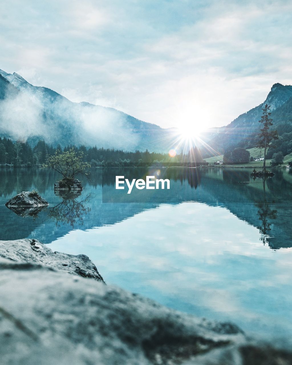 Scenic view of lake and mountains against sky