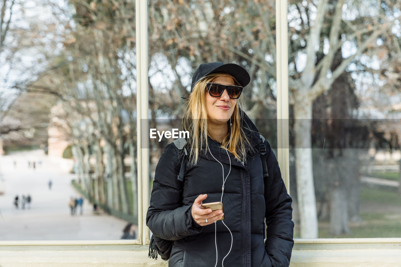 Woman listening music in city