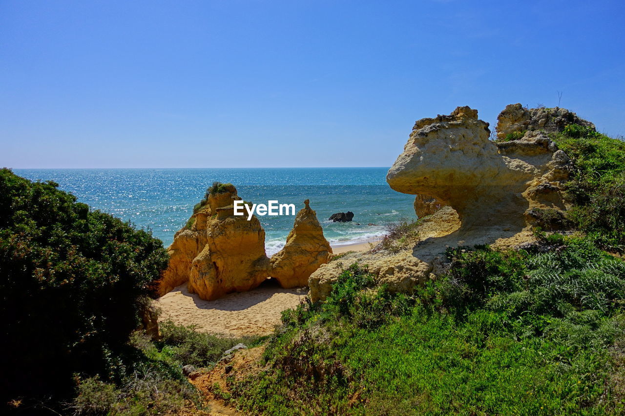 Scenic view of sea against clear blue sky