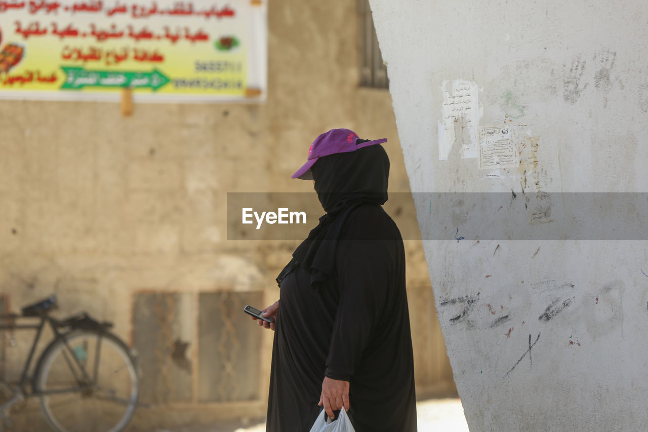 Woman standing against wall