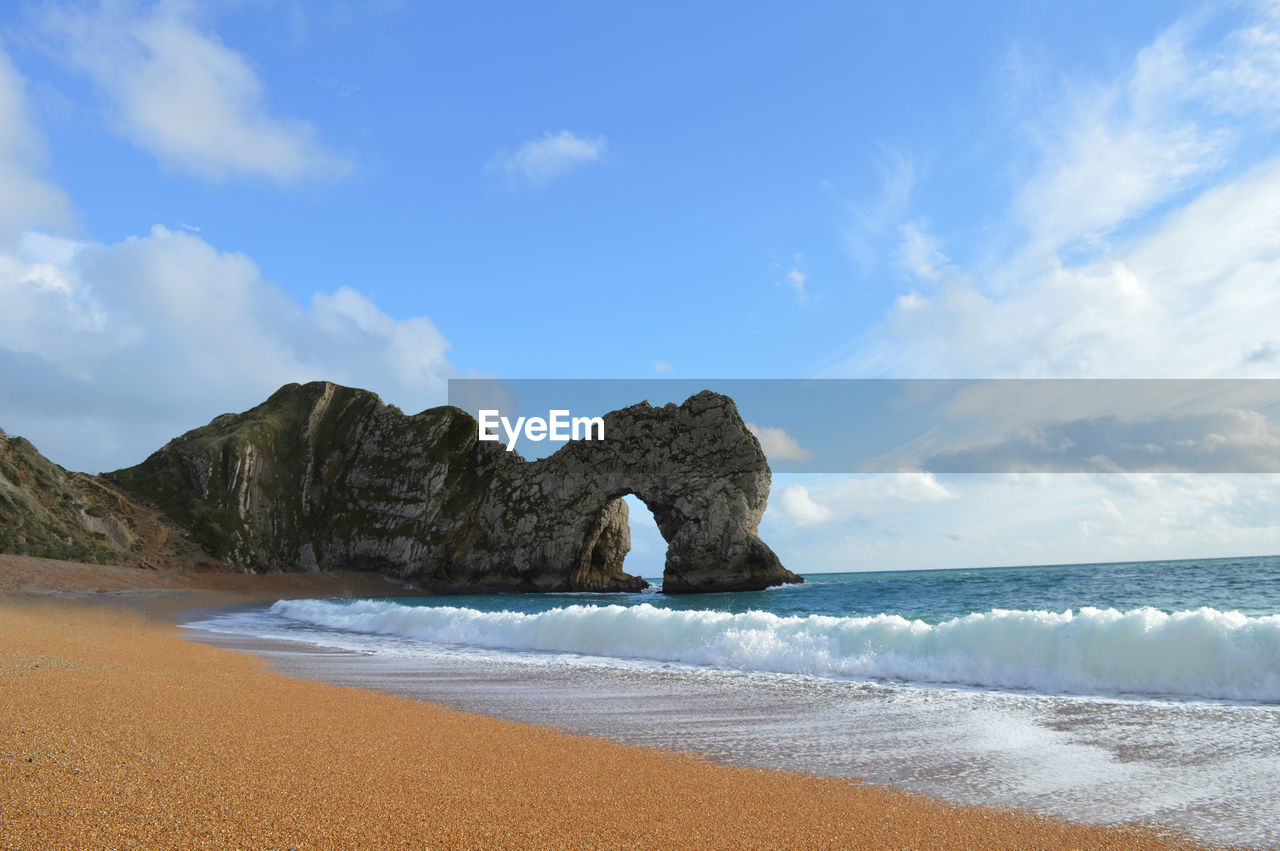 Waves reaching on shore at durdle door