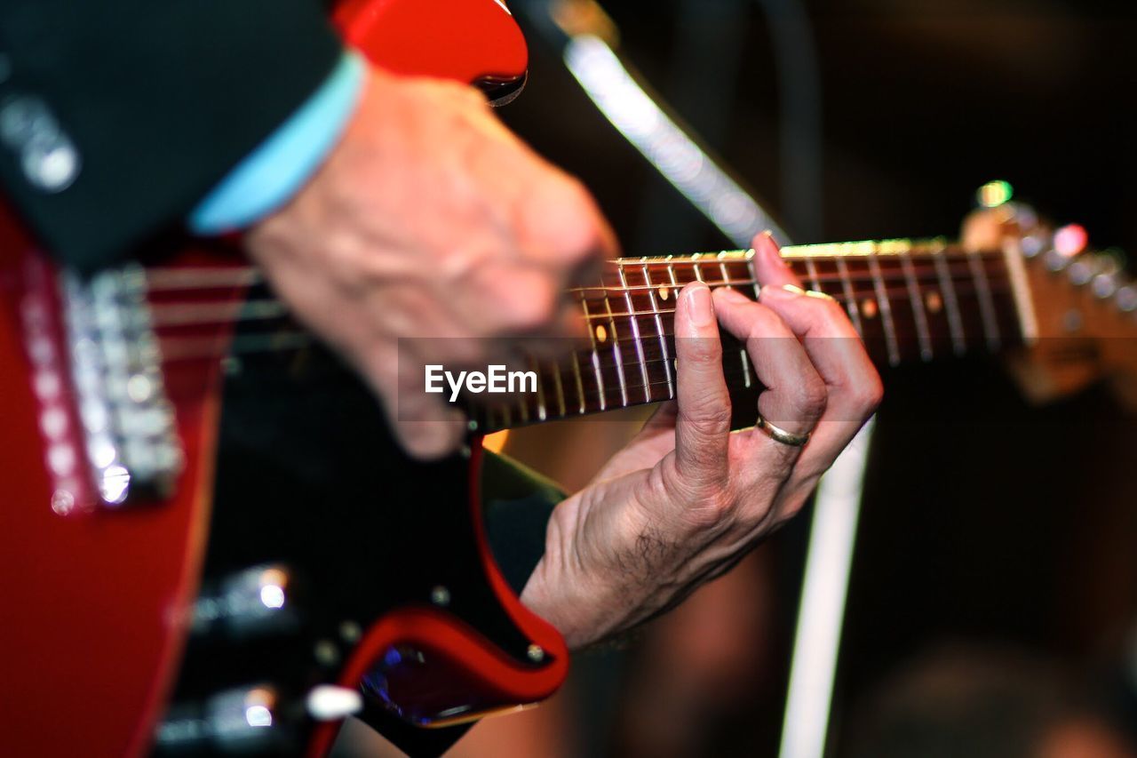 Close-up of hands playing guitar