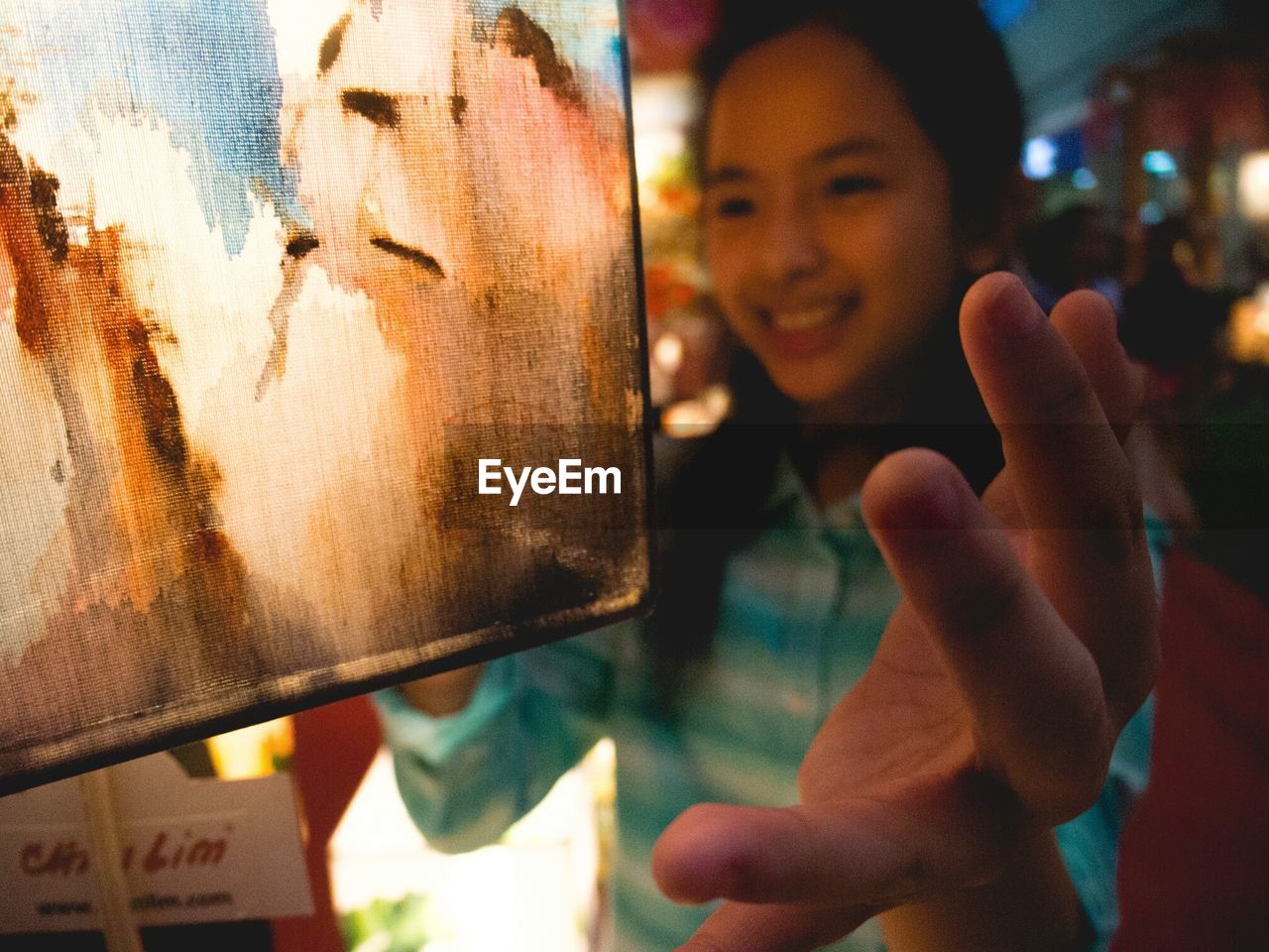 showing, looking at camera, real people, smiling, one person, focus on foreground, portrait, childhood, human hand, close-up, standing, outdoors, happiness, day, people