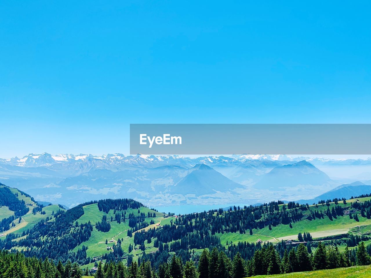 Scenic view of mountains against clear blue sky