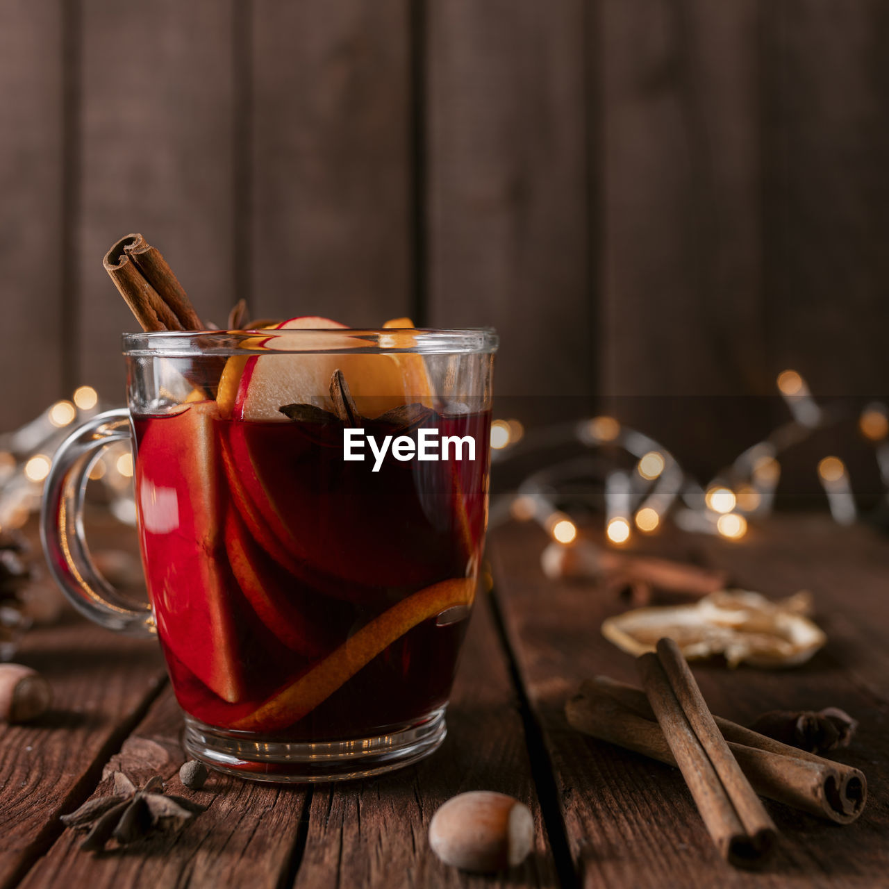 Glass cup of mulled wine on wooden table and background. christmas time concept