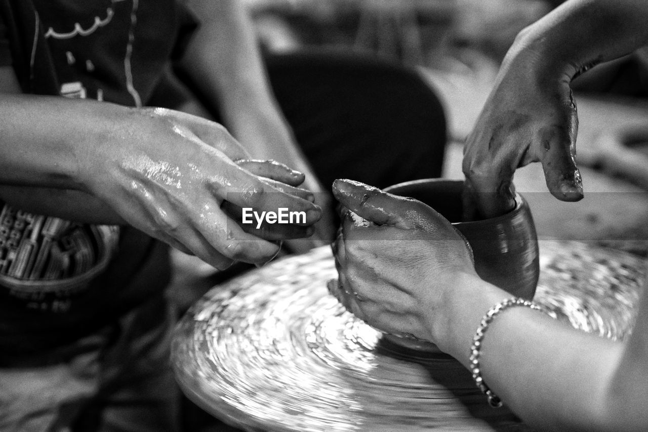 People working on pottery wheel