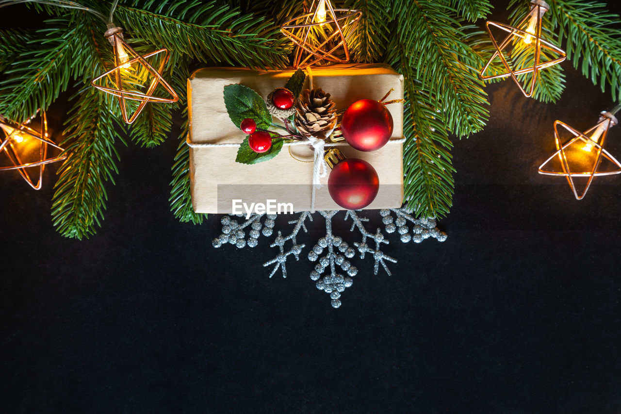 Holiday christmas with decoration ball, stars,snowflakes, gift box, pine cones on a black background