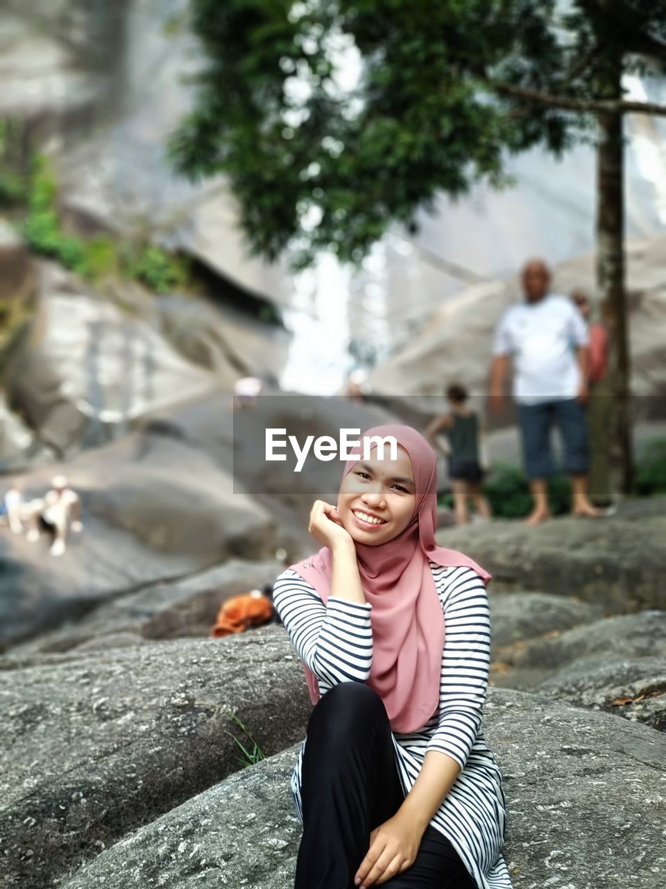 Woman sitting on rock