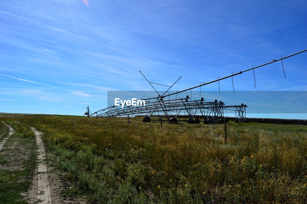 Agricultural machinery on farm against sky