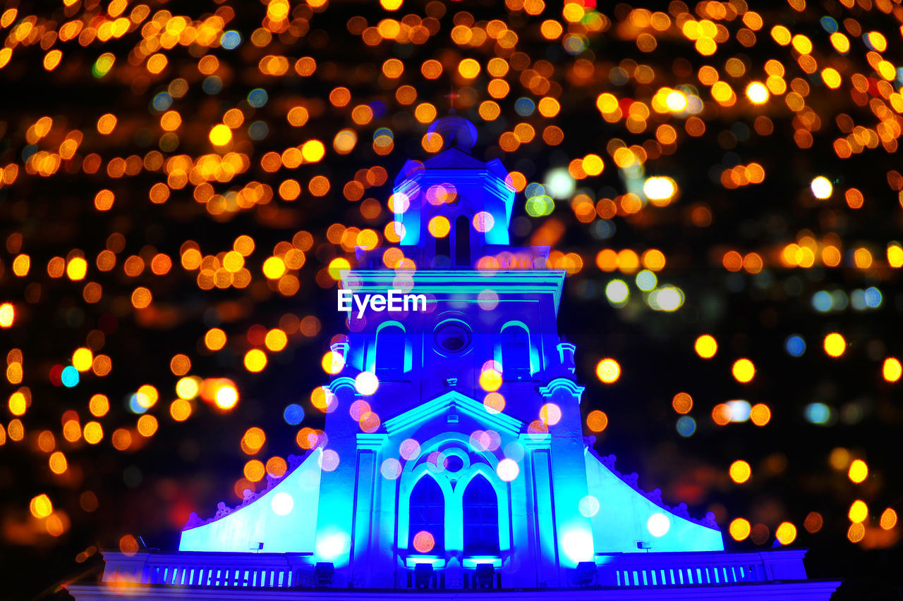 VIEW OF ILLUMINATED CITY AT NIGHT