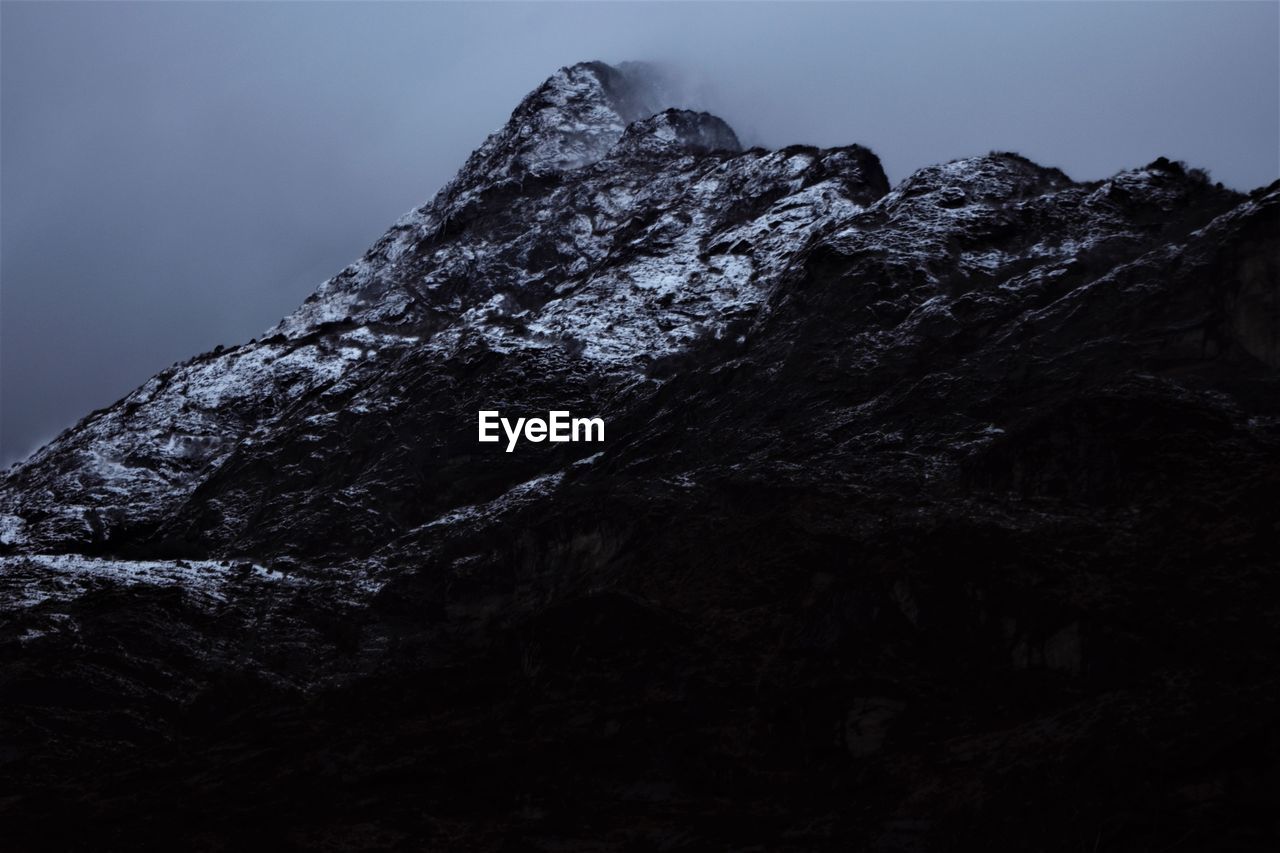 Low angle view of rock formation against sky