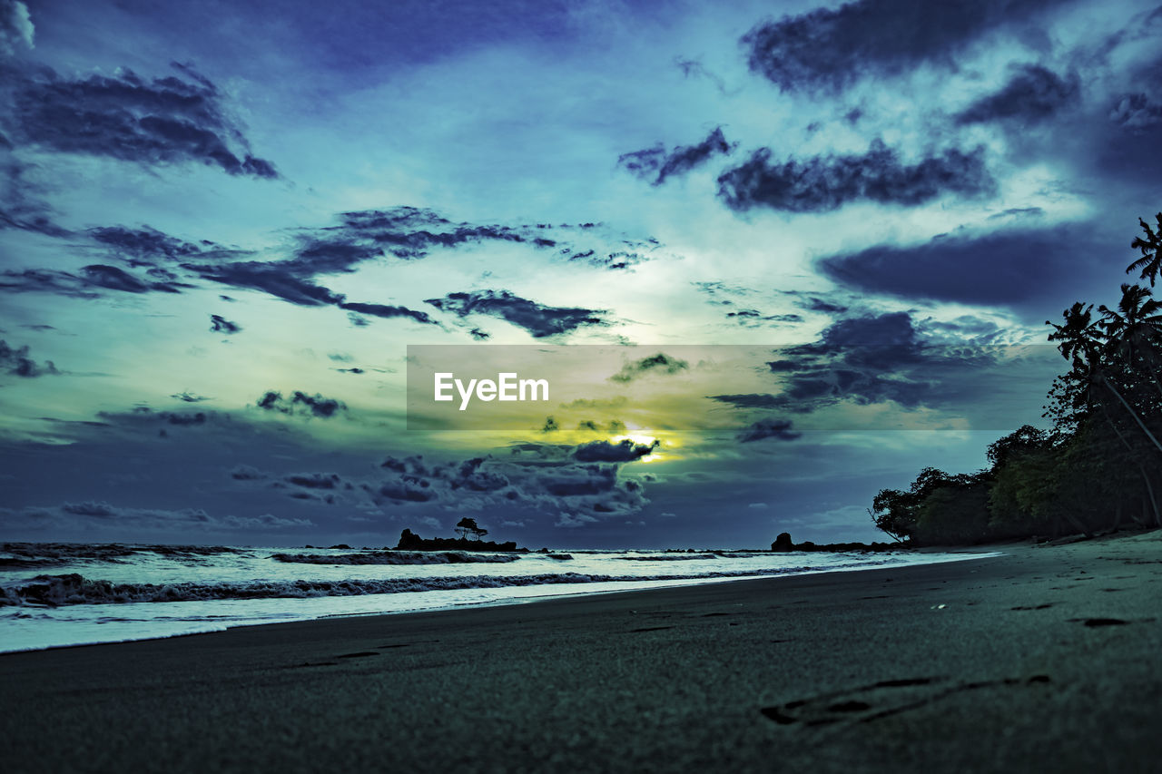 SCENIC VIEW OF BEACH DURING SUNSET