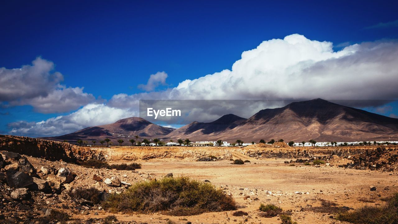 Scenic view of mountains against cloudy sky