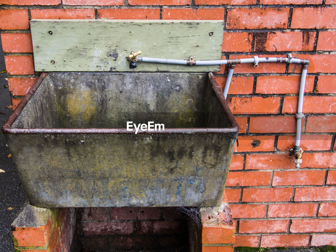 CLOSE-UP OF PIPES AGAINST WALL