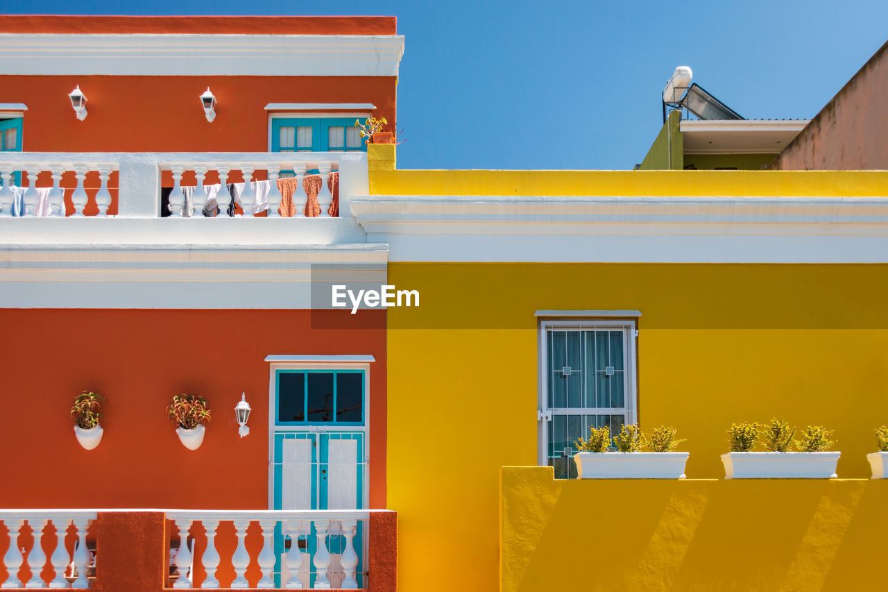 Colorful facades of old houses in orange and yellow, bo kaap malay quarter, cape town, south africa