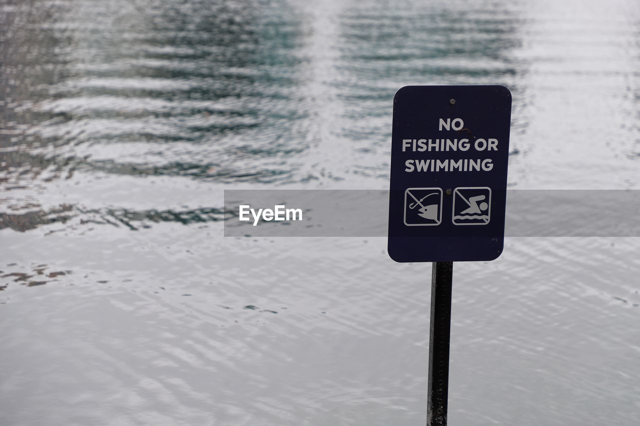 No fishing or swimming sign at edge of water
