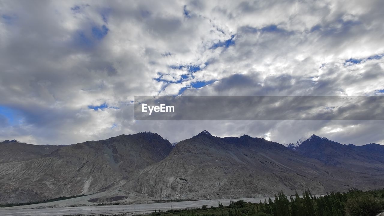 mountain, cloud, environment, sky, landscape, scenics - nature, nature, beauty in nature, mountain range, land, no people, travel destinations, travel, non-urban scene, wilderness, tranquility, outdoors, tranquil scene, snow, tourism, plant, panoramic, horizon, plateau, day, dramatic sky, lake, tree