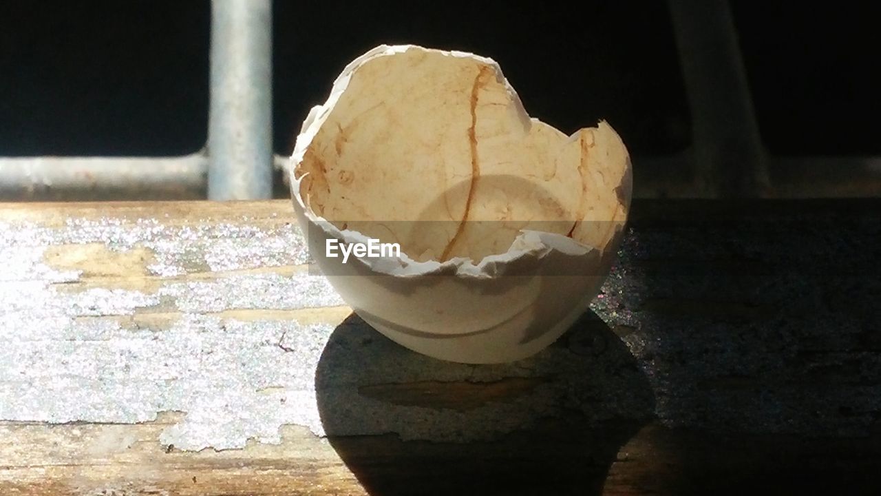 High angle view of broken eggshell on window sill