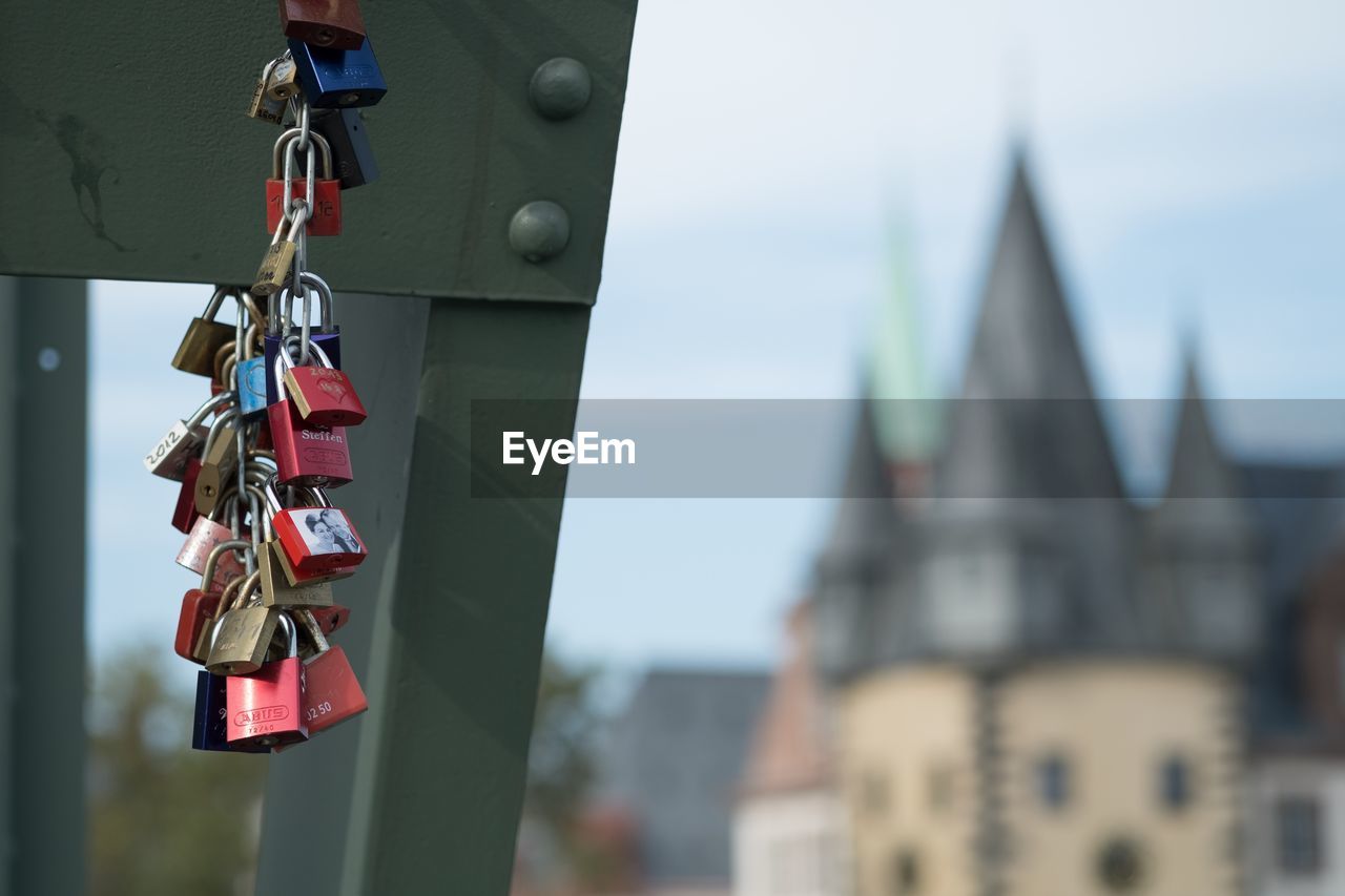 Close-up of padlocks on chain against sky