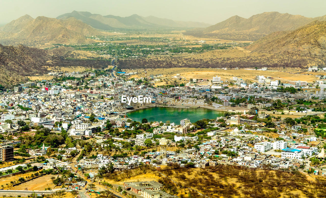 High angle view of townscape and river in city