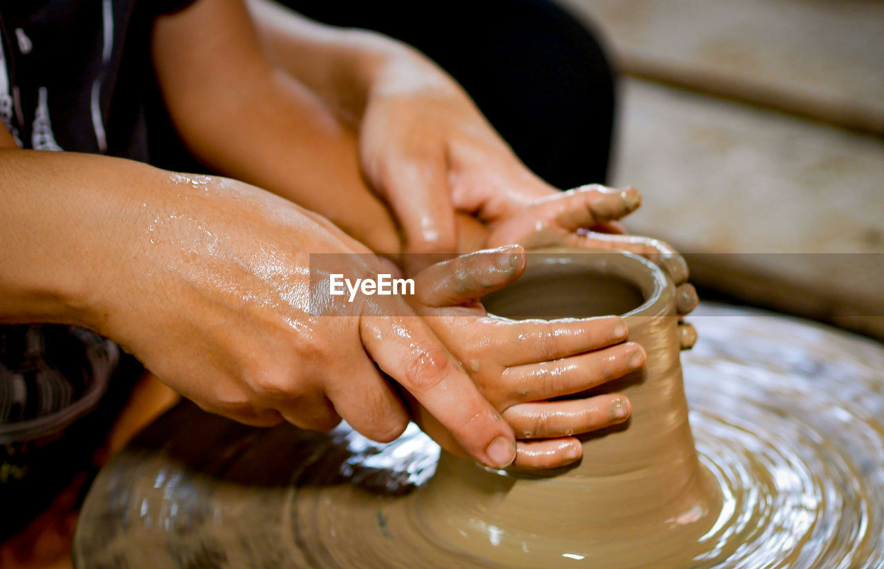 Close-up of cropped hands doing pottery