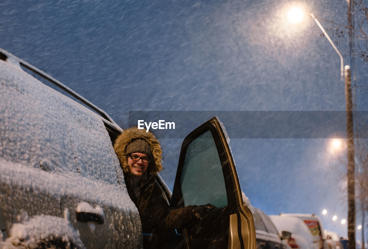 Portrait of man in car in winter blizzard