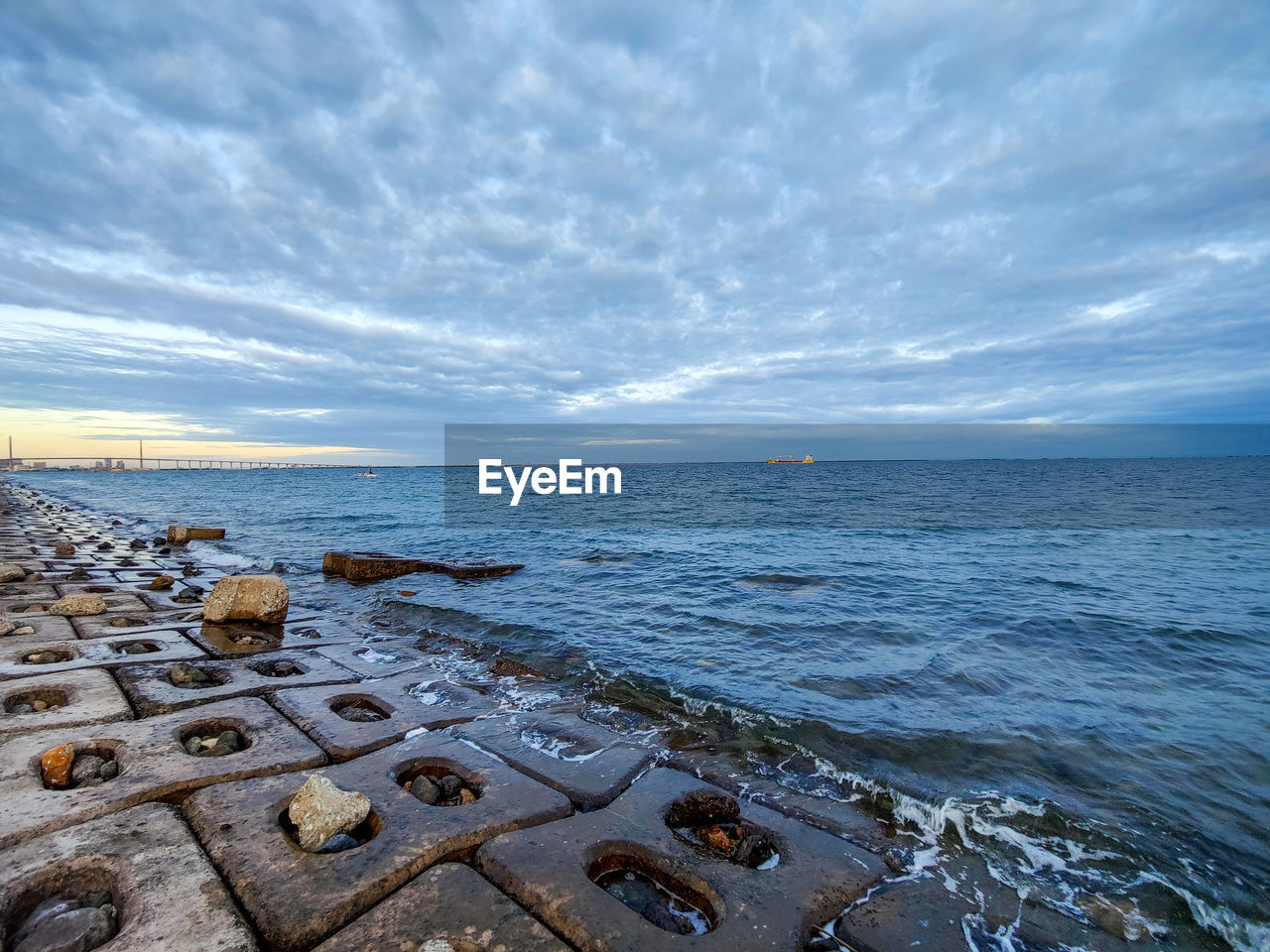 sea, water, sky, horizon, shore, ocean, coast, cloud, rock, beach, land, nature, scenics - nature, body of water, beauty in nature, wave, horizon over water, tranquility, seascape, no people, travel destinations, outdoors, tranquil scene, travel, environment, wind wave, coastline, day, blue, sand, reflection, sunset, tourism, urban skyline, architecture, bay, landscape