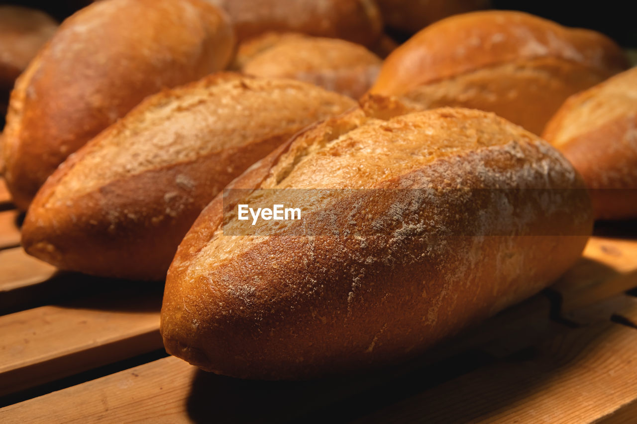 food, food and drink, bread, freshness, baked, loaf of bread, store, bakery, fast food, no people, close-up, brown, baguette, healthy eating, wheat, rustic, bread roll, table, wellbeing, whole wheat, bun, whole grain, wood, french food, indoors, still life, basket, crop, cereal plant, gourmet, dessert, flour, group of objects