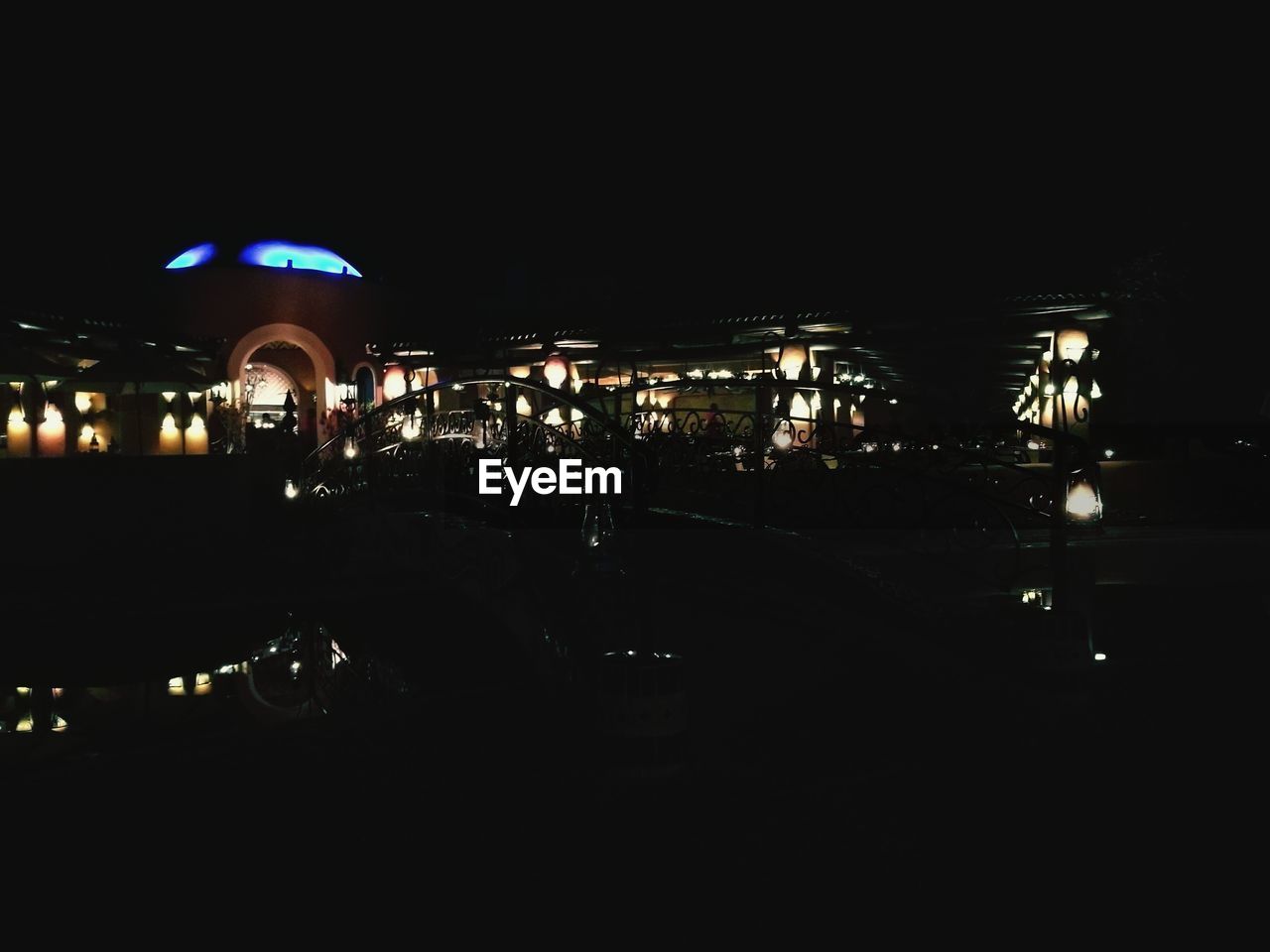 VIEW OF ILLUMINATED STREET LIGHTS AT NIGHT