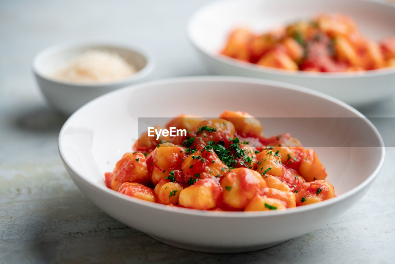 Gnocchi with tomato sauce and parmigiano on a plate