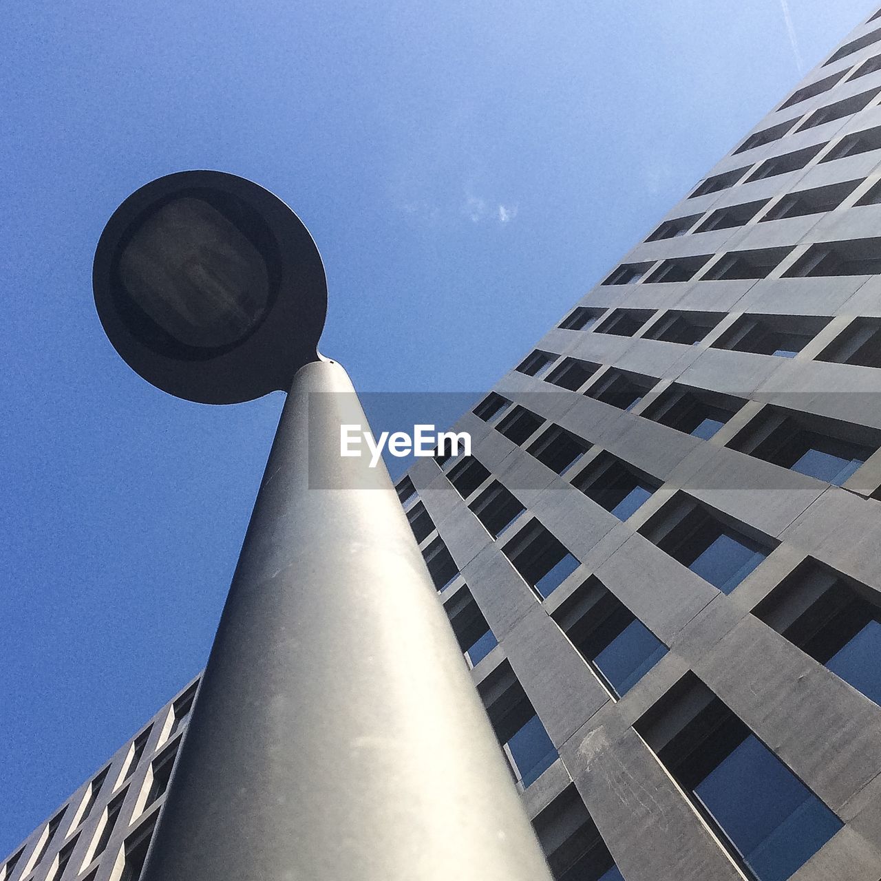 Low angle view of street light and building against sky