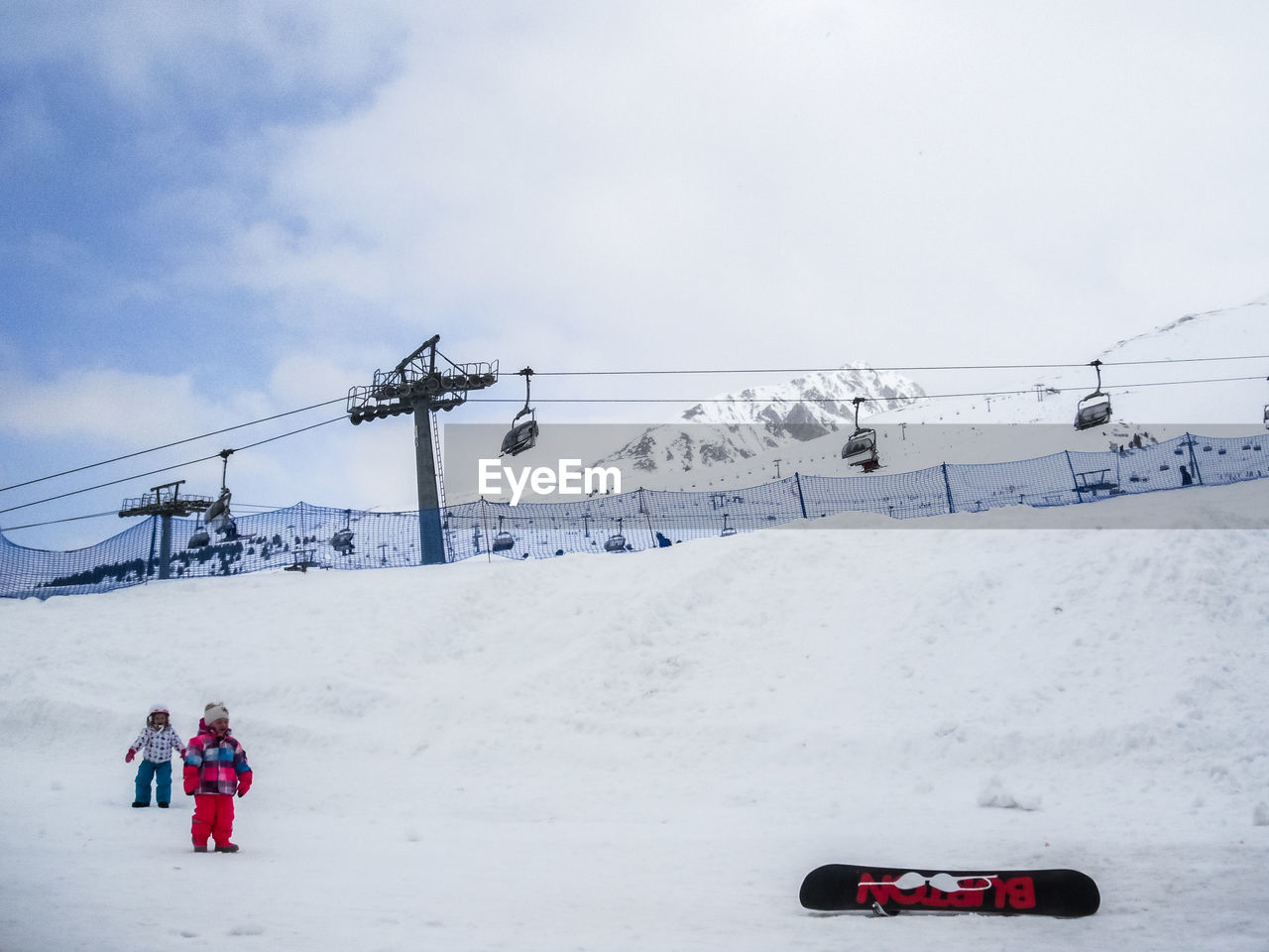 OVERHEAD CABLE CAR ON SNOW COVERED MOUNTAINS