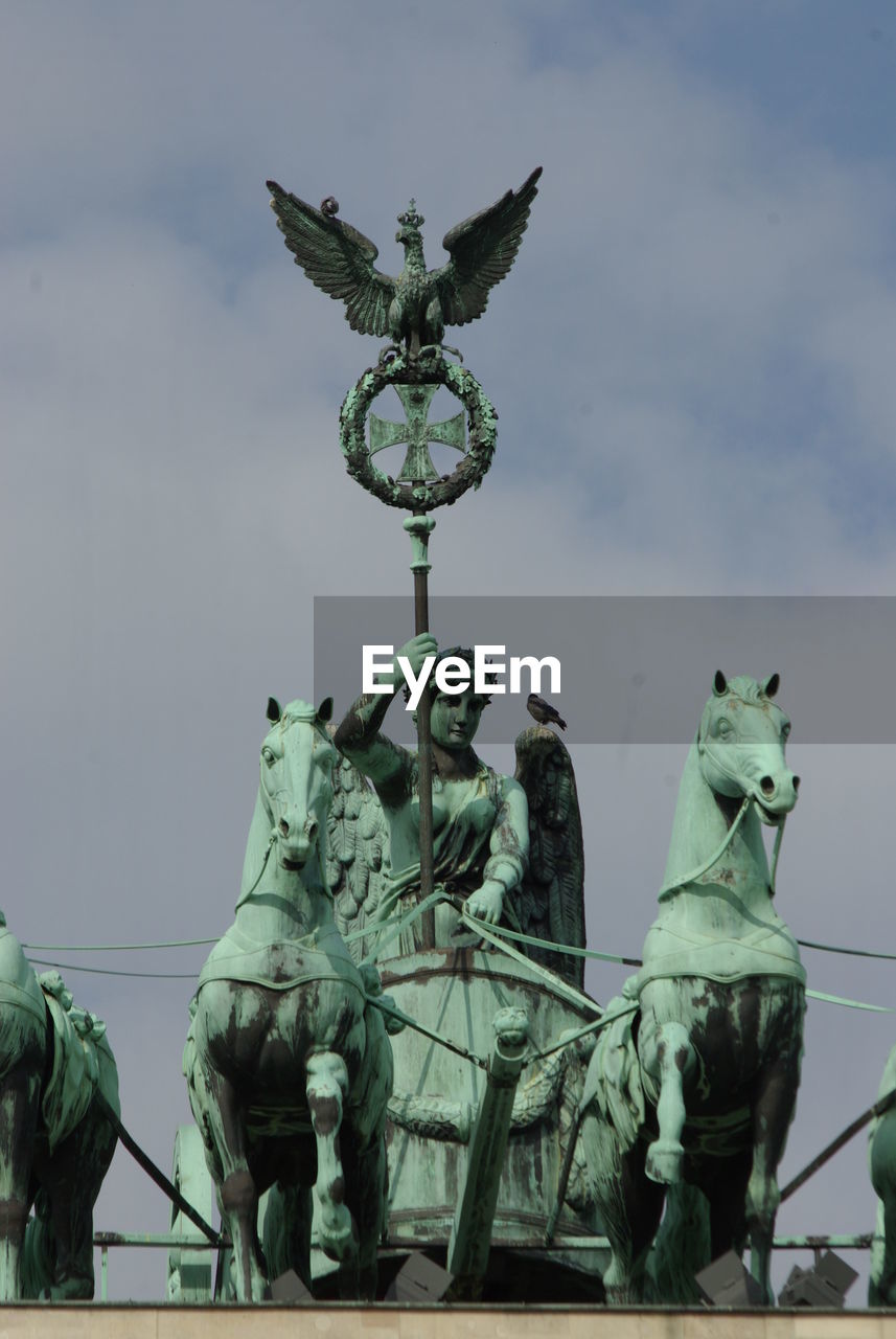 Low angle view of statue against sky