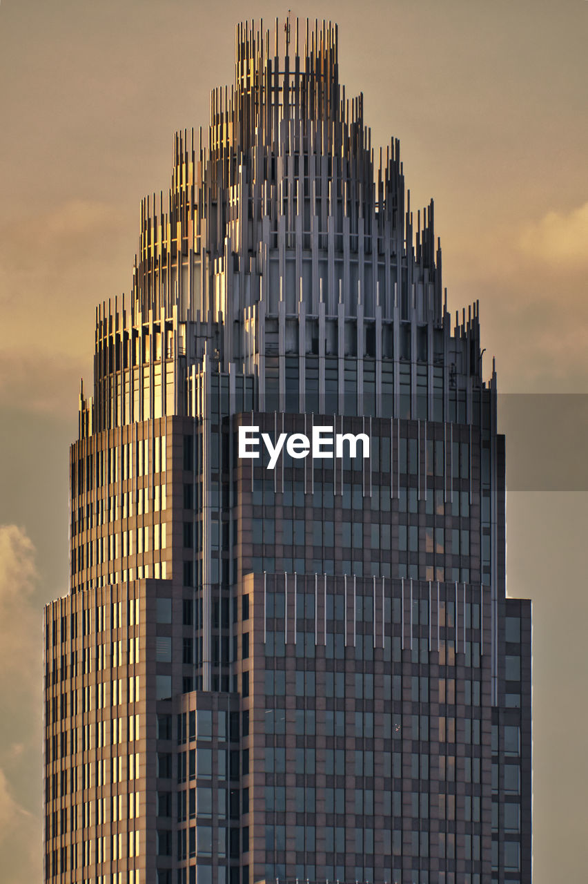 low angle view of skyscrapers against sky at dusk