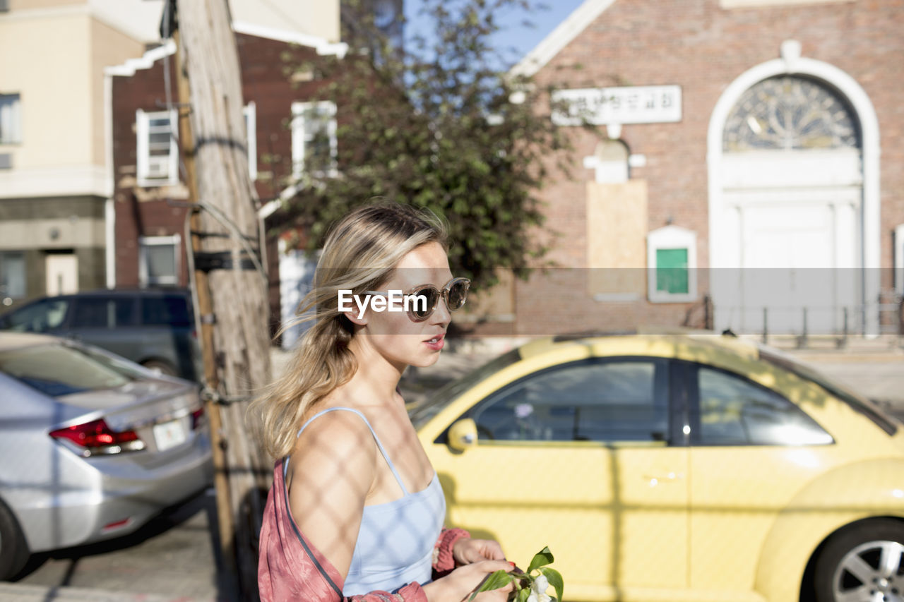 Young woman walking along a street