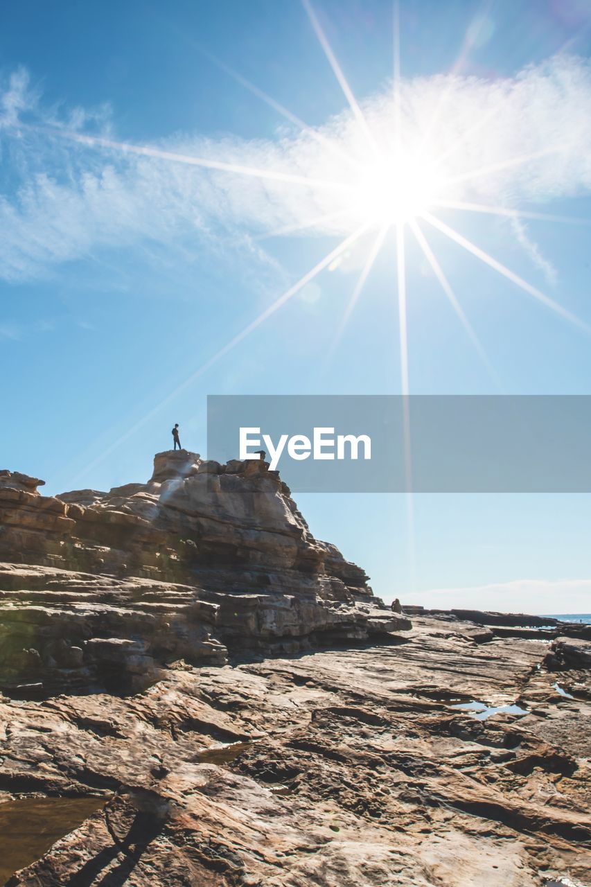 low angle view of rock formations against sky