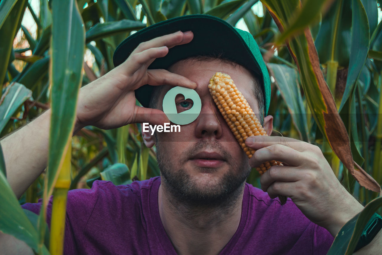 Close-up of man holding corn