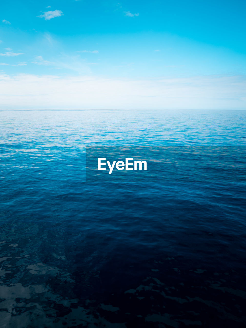 Scenic view of sea against blue sky