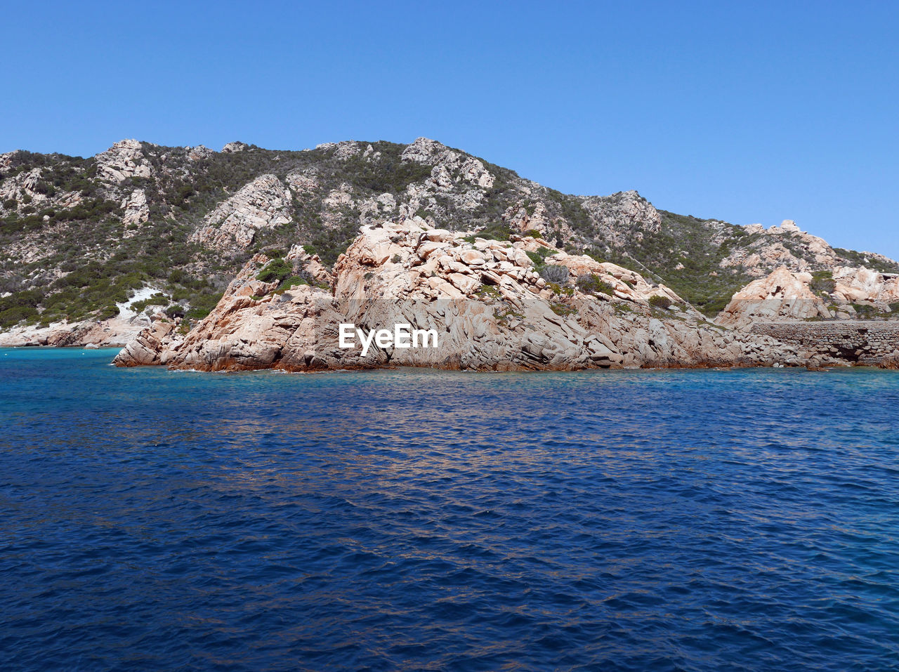 Scenic view of sea against clear blue sky