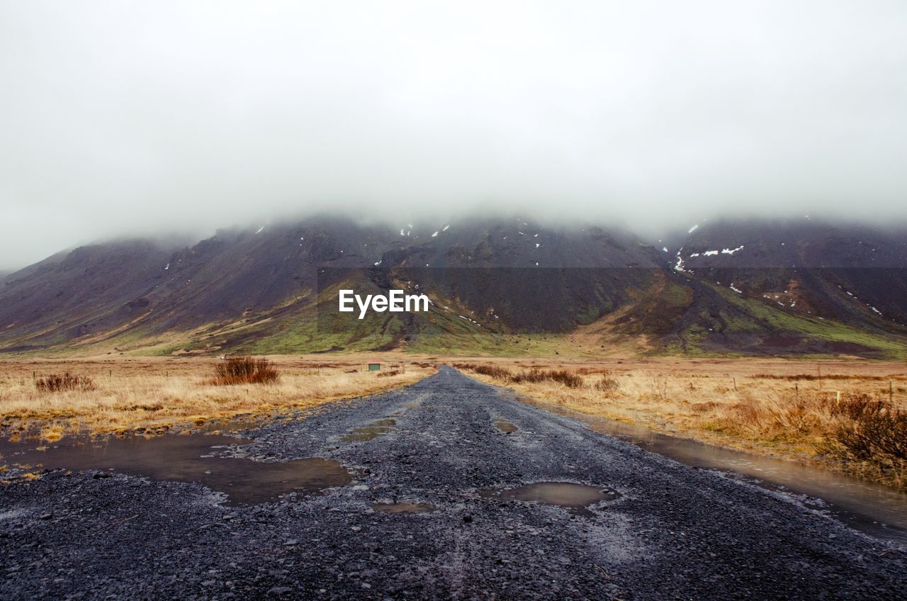 ROAD LEADING TOWARDS MOUNTAINS