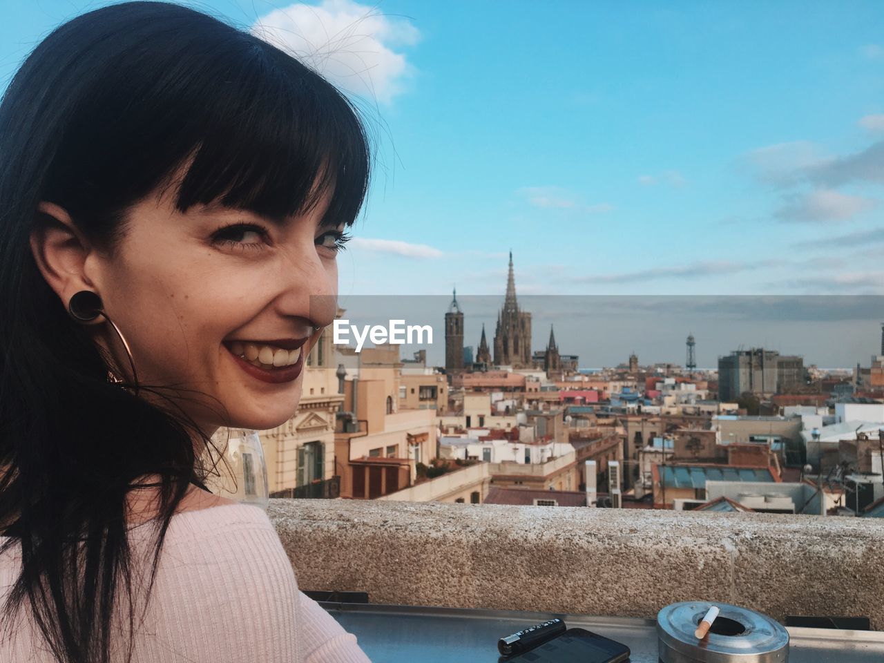 PORTRAIT OF WOMAN LOOKING AT CITY