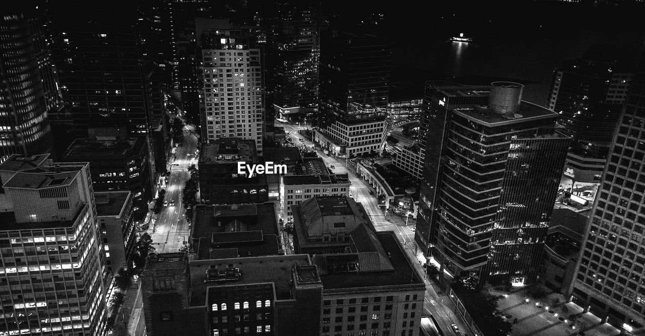 High angle view of illuminated buildings in city at night