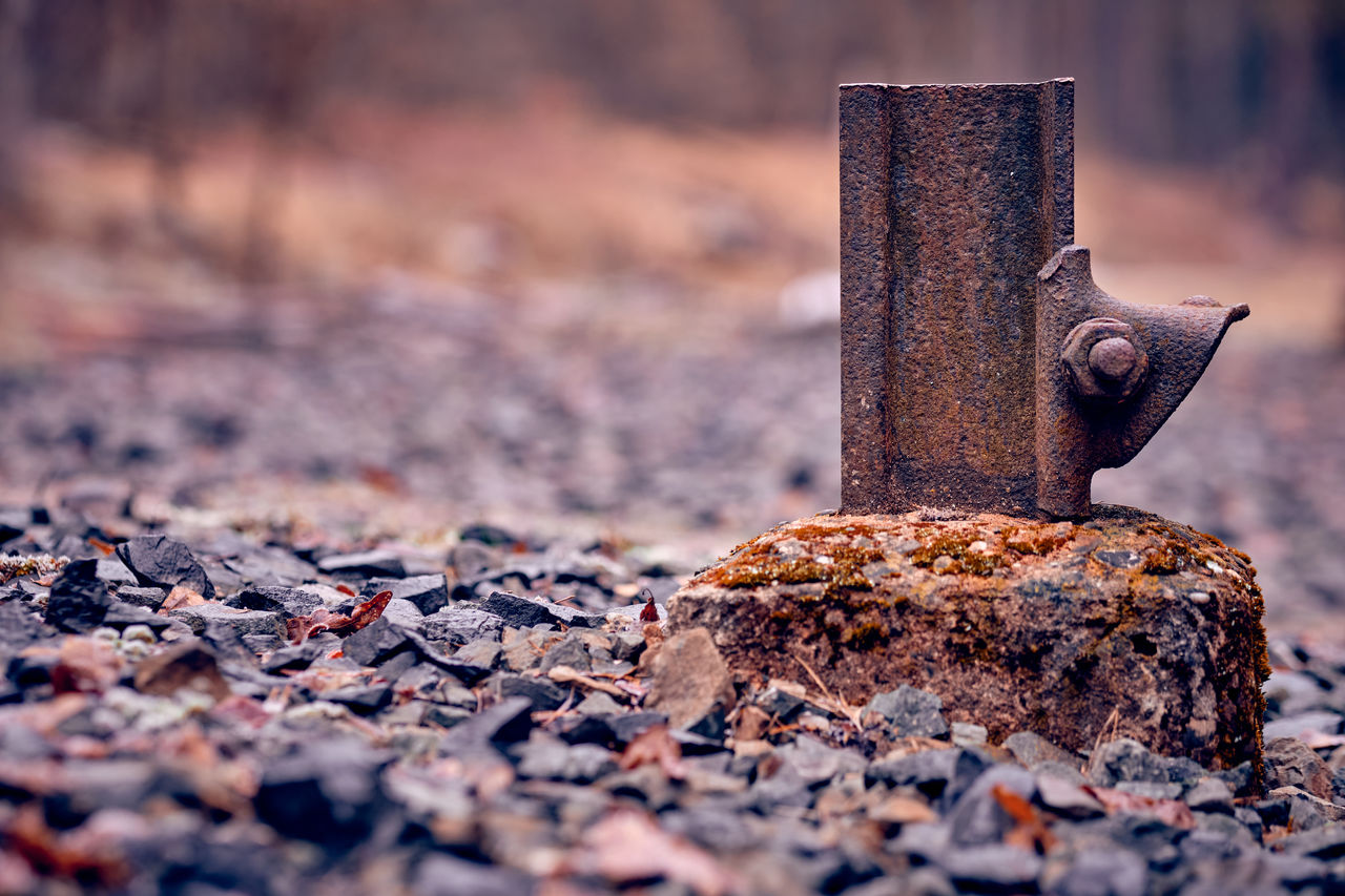 CLOSE-UP OF OLD RUSTY METAL ON WOOD