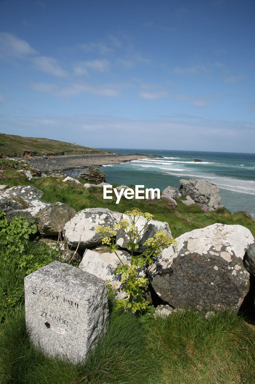 SCENIC VIEW OF SEA SHORE AGAINST SKY