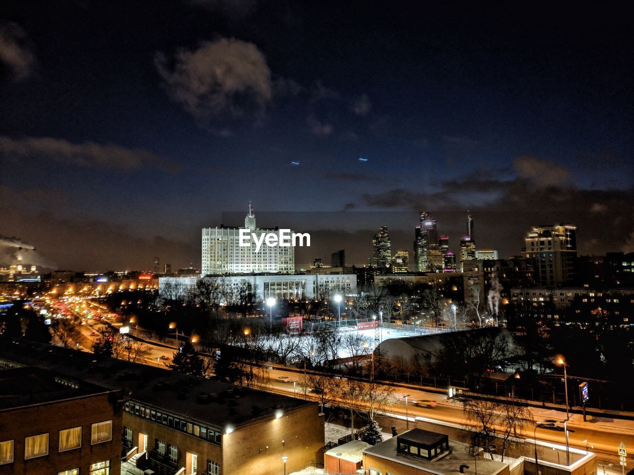 High angle view of city lit up at night